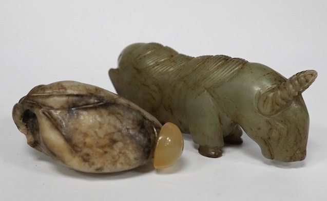 A Chinese white and black jade pendant now hollowed as a snuff bottle, and a Chinese celadon jade figure of a buffalo. Condition - fair to good